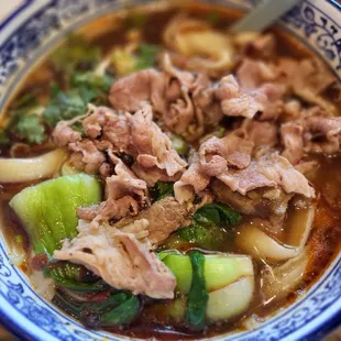 Spicy prime beef / knife cut noodle soup.