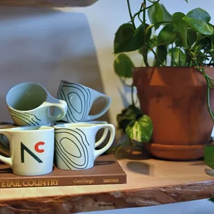 a stack of mugs on a shelf