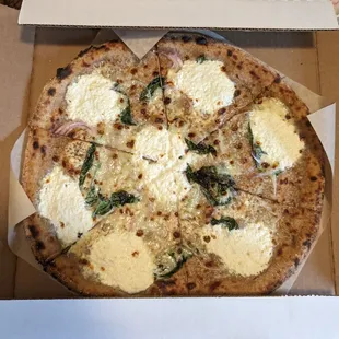 Blanca pizza - green garlic, red onion, cream, basil, mozzarella, cheddar, and ricotta
