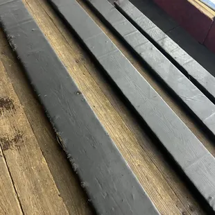 Seating for fans.  Wood floor, vinyl covered wood seats.