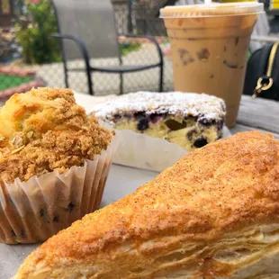 Blueberry muffin, apple turnover, coffee cake wit blueberries and a Vietnamese Iced coffee