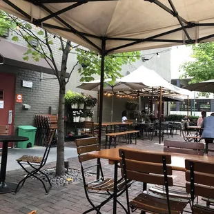 tables and chairs under an umbrella
