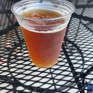 a cup of beer on a table