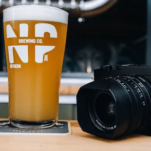 a glass of beer and a camera