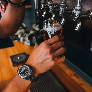 a man pouring a beer