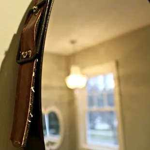 Items on the wall are adorable and feel historic. This leather mirror was one of my favorites.