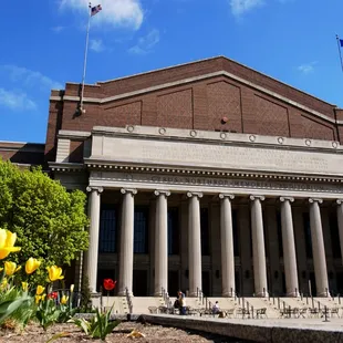 the front of a building with columns and columns