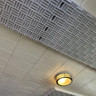 Acoustic tiles along the ceiling. Nice attention to detail.