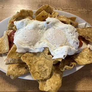 Huevos Rancheros. This is actually a bean burrito (beans in folded flour tortilla), with sauce topped by eggs and surrounded by chips.