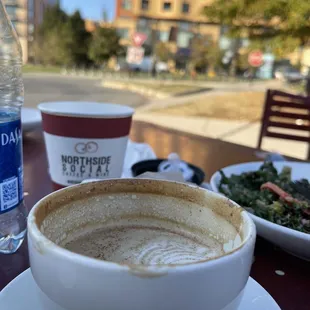 a cup of coffee and a plate of salad