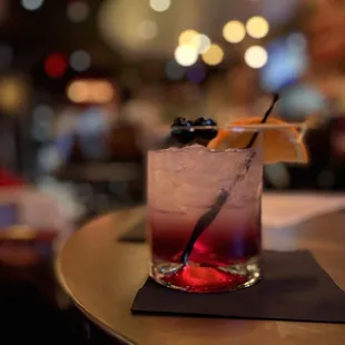 a cocktail with a garnish garnish