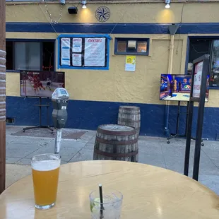a table with a drink and a parking meter