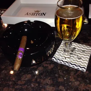 a glass of beer and a cigar