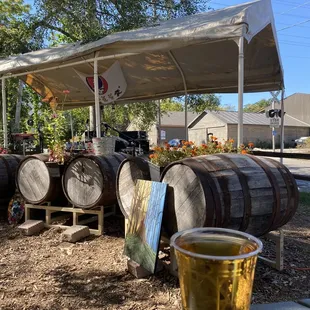 a glass of beer and barrels