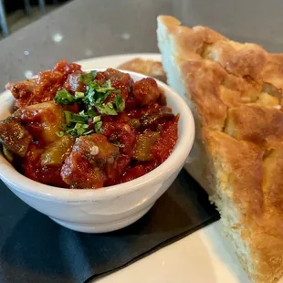 Caponata Sicilian bleand of tomato, eggplant, green olives, capers, vinegar and herbs. Served housemade focaccia.