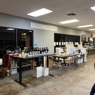 a man walking through a wine tasting room