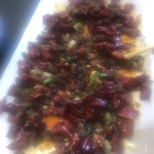 Lots of small fried lamb bits mixed with chili pods