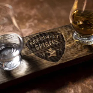 three glasses of alcohol on a wooden tray