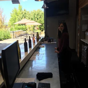 a woman standing at the bar