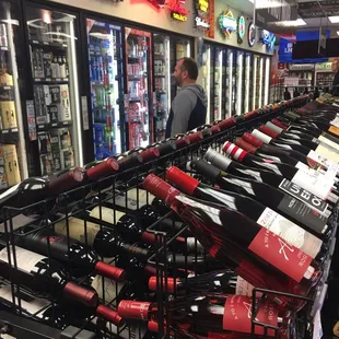 rows of bottles of wine in a store