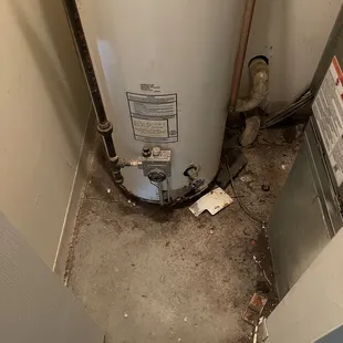 Dirt and mouse trap in water heater closet.
