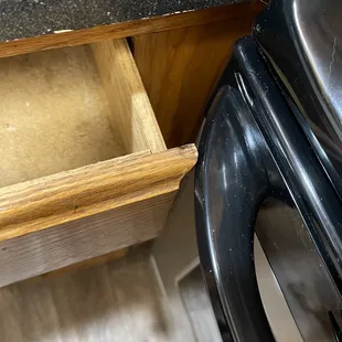 Drawer won't even open because of oven door handle. (We were told this is in most every unit)