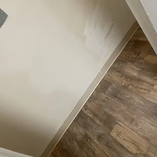 Unfinished painted walls where the washer/dryer should go.