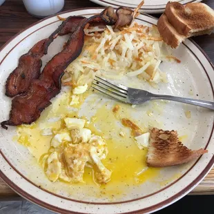 Eggs, hash browns, bacon and toast- half eaten. ALL AMAZING
