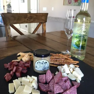 cheese, salamie, crackers, and a bottle of wine