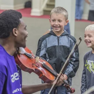 two young boys playing violin
