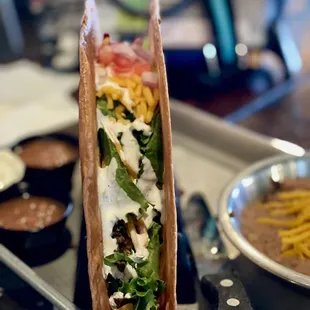 a taco with cheese and lettuce