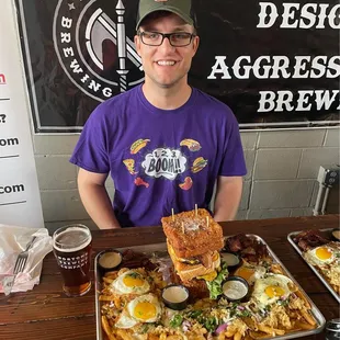 a man holding a tray of food