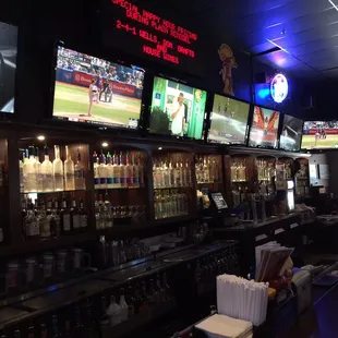 Lots of TVs with full liquor bare