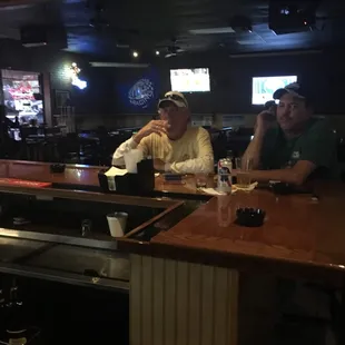 two men sitting at the bar