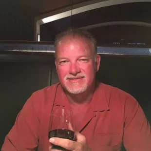 a man holding a glass of wine