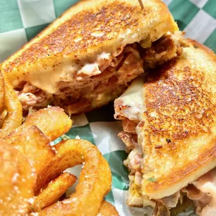 a grilled sandwich and onion rings