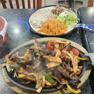 Beans rice guacamole sour cream and fajitas
