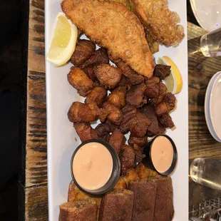 a platter of fried fish and fries
