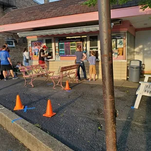 a group of people standing in front of a store