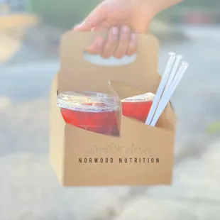 a person holding a box of food