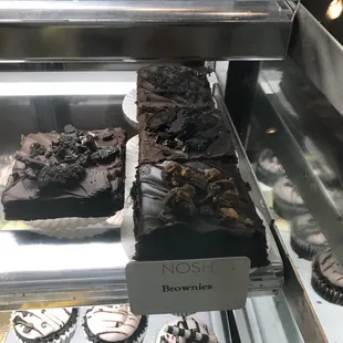 a display case with a variety of desserts