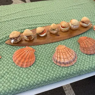 a table with sandwiches and shells on it