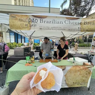a person holding a piece of bread in their hand