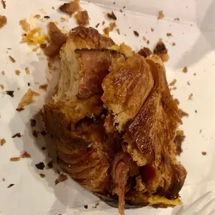 Burnt egg and bacon on croissant