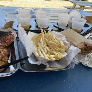 Parm fries, Nashville hot tenders and the last bite of that jerk chicken eggroll.   (Cider flight from Sly Clyde Ciderworks)