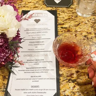 a menu and a glass of wine