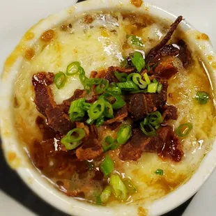 French Onion soup topped with crispy bacon and green onion