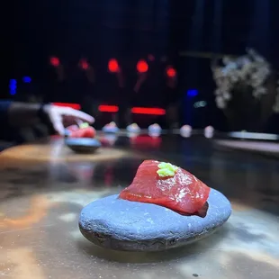 a piece of sushi on a rock