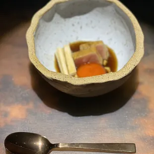 a bowl of food and a spoon