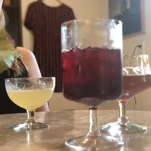 L-R: gimlet, dry wine-based cocktail, champinion dreams canned cocktail (poured to a glass)